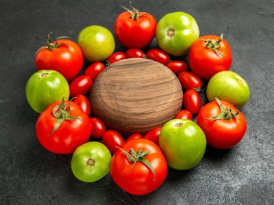 bottom-view-cherry-red-green-tomatoes-around-wooden-plate-dark-ground (1)