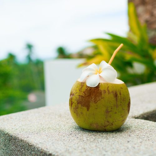 tropical-coconut-cocktail-decorated-plumeria-table